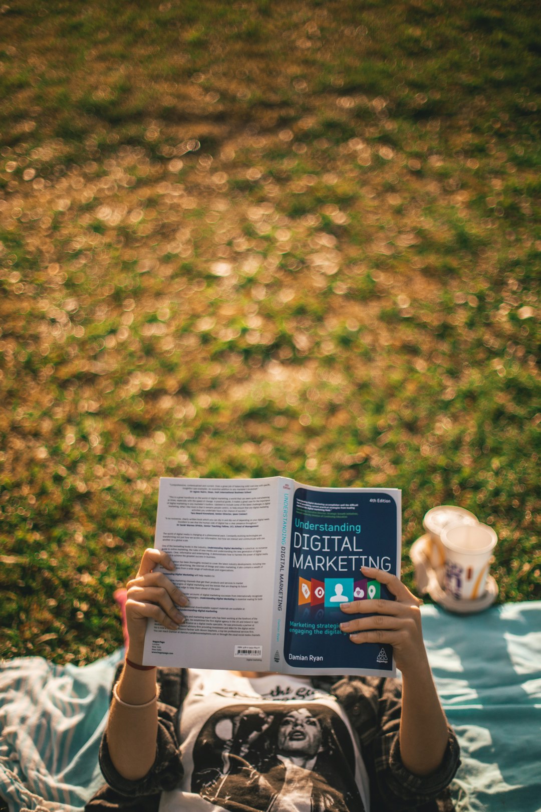 Girl reading a book about Digital Marketing